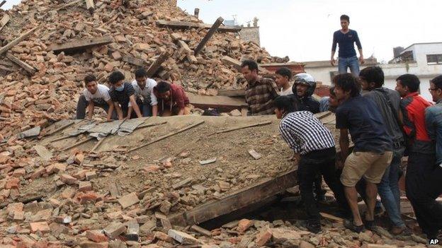 People try to lift the debris from a temple at Hanumandhoka Durbar Square in Kathmandu (26 April 2015)