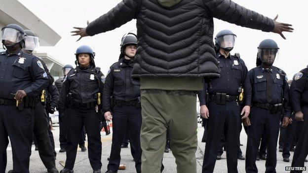 A demonstrator gestures towards a line of police near Camden Yards during a protest against the death in police custody of Freddie Gray in Baltimore April 25, 2015