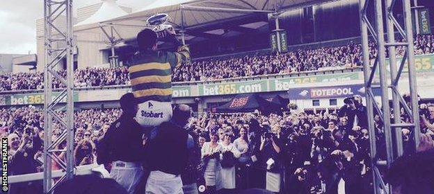 AP McCoy is raised aloft by colleagues