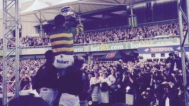 AP McCoy is raised aloft by colleagues