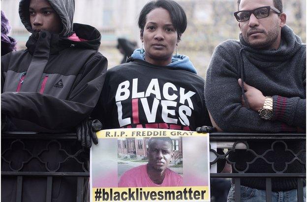 Woman holding #blacklivesmatter sign