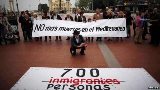 People hold a banner reading "No more deaths in the Mediterranean" during a protest against the current immigration policy of the European Union in Malaga