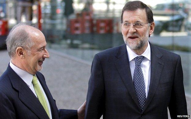 Rodrigo Rato (L) with PM Mariano Rajoy (R)