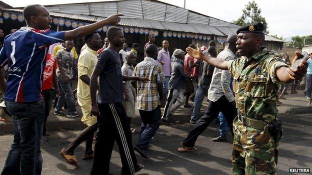 A military officer tries to control protesters in Bujumbura, April 27, 2015