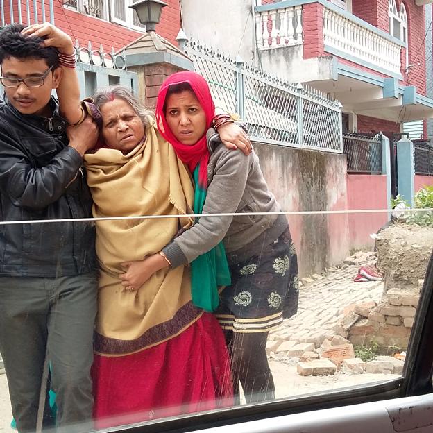 Injured woman being helped by two people