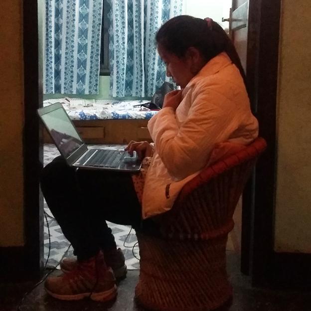 Bhrikuti Rai at home sitting in a doorway