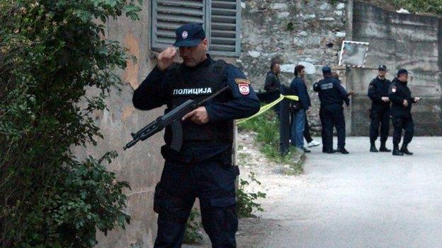 Members of special police take position in front of an attacked police station in Zvornik, April 27, 2015.