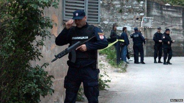 Members of special police take position in front of an attacked police station in Zvornik, April 27, 2015.