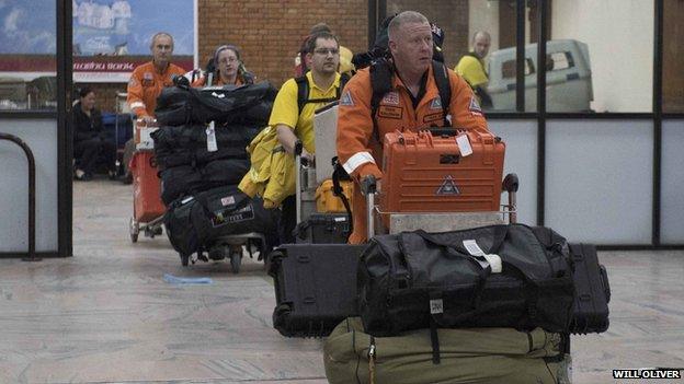 Rescue workers from British charity SARAID (Search and Rescue Assistance in Disasters) arrive at Kathmandu airport in Nepal