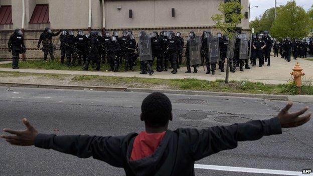 A protestor gestures to police