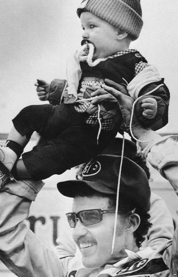 Adam Petty being held aloft by his grandfather Richard