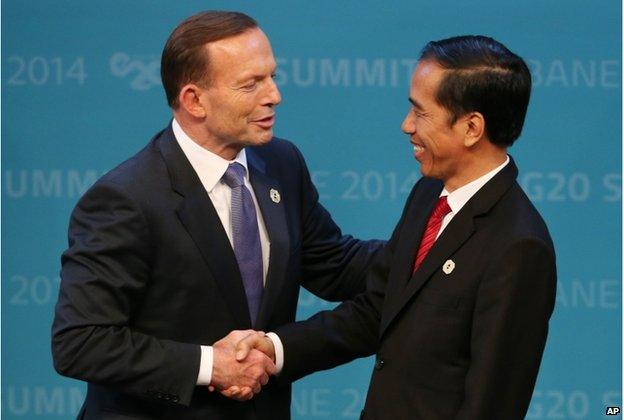 In this 15 November 2014, file photo, Australian Prime Minister Tony Abbott, left, shakes hands with Indonesian President Joko Widodo at the G-20 summit in Brisbane, Australia