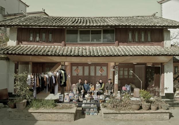 Aer Yingming and her family outside their home