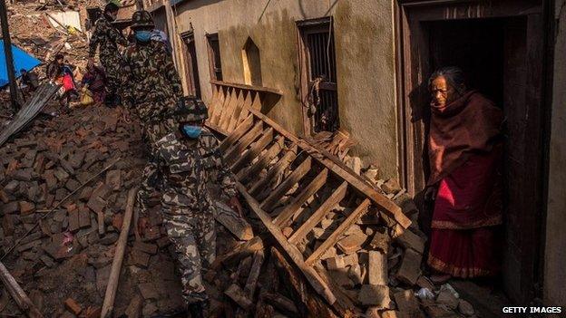 Nepalese Rangers soldiers walk among debris of houses on 29 April 2015 in Bhaktapur, Nepal.