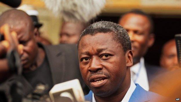 Togo"s Incumbent President Faure Gnassingbe speaks to media after he casting his ballot at a polling station in Lome, Togo, Saturday, April 25, 2015