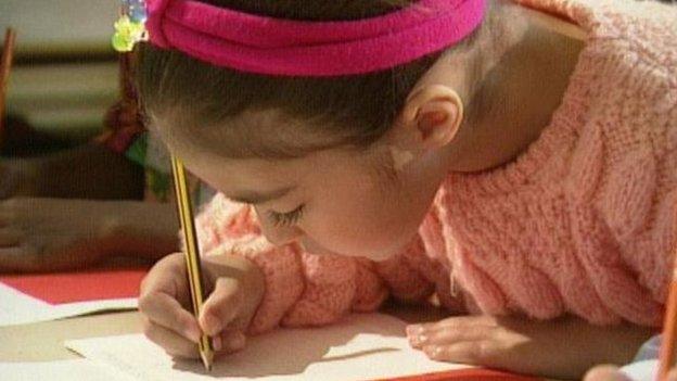 Girl writing at desk