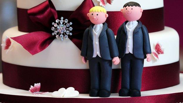 Same-sex marriage figures on wedding cake