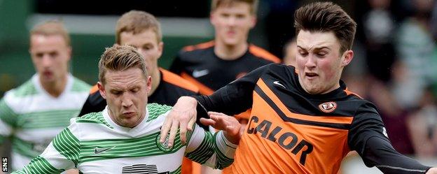 Celtic's Kris Commons is challenged by Dundee United's John Souttar