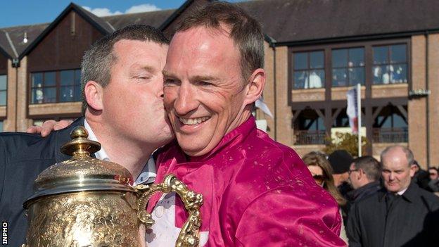 Trainer Gordon Elliott kisses jockey Paul Carberry after Don Cossack's win in the Punchestown Gold Cup