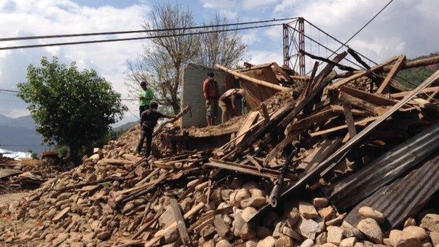 Men clearing the rubble in the village of Deupur Sipaghat Kavre after the earthquake in Nepal, 30 April 2015