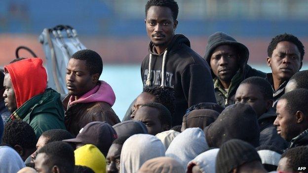 Rescued migrants disembark at the Sicilian harbour of Catania on 23 April 2015