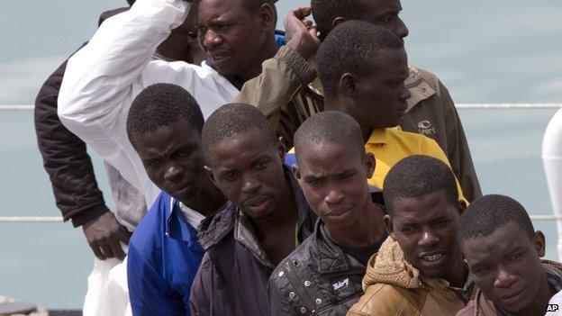 Migrants wait to disembark from the Italian Coast Guard ship Fiorillo, at the Catania harbor, Sicily, southern Italy, Friday, April 24, 2015.