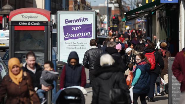 File image from 2013, featuring a poster warning that benefits were changing