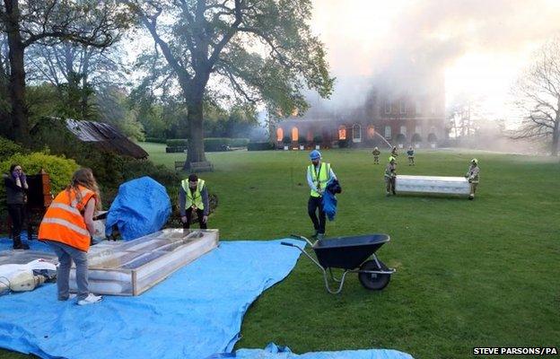 Firefighters battle a blaze at Clandon Park