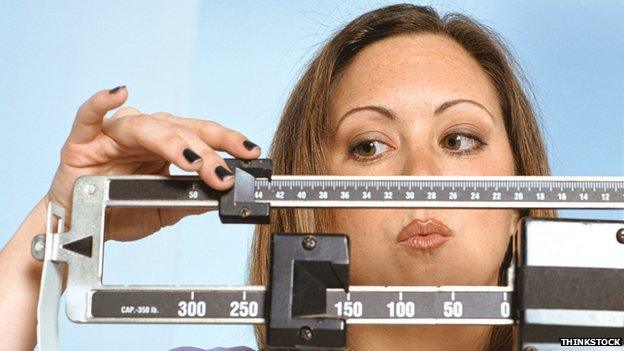 Woman weighing herself