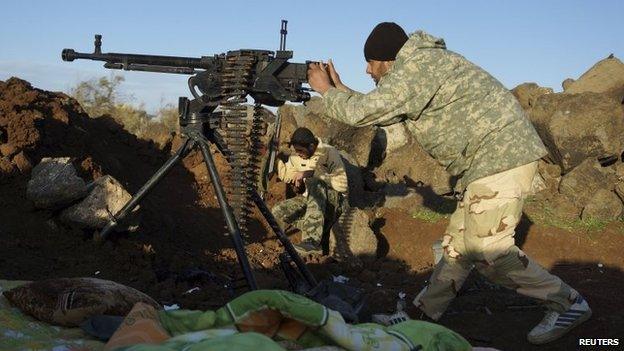 Member of the Southern Front rebel coalition fires a machine gun in Deraa, Syria (4 March 2015)