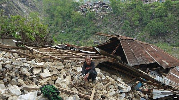 Villager sits amid collapsed home in destroyed village of Jalingi, near epicentre of earthquake, in Gorkha District of Nepal. 30 Apr 2015