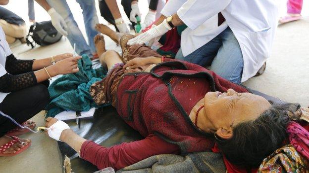 Nepali woman injured in a remote area of the Gorkha district screams in pain as she is treated by Nepali doctors in Ghorka on 30 April, 2015