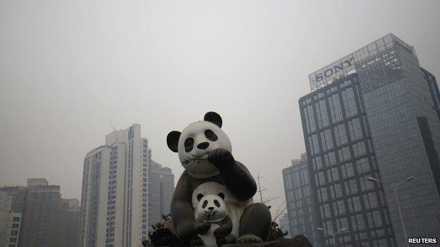 Statues of Pandas are seen on a polluted day in Beijing on 14 January, 2015