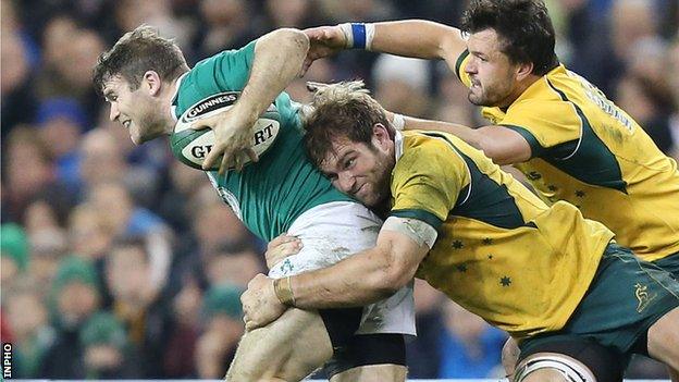 Gordon D'Arcy is tackled by Australian pair Adam Ashley-Cooper and Ben McCalman