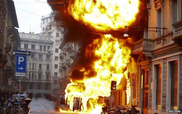 Cars are set on fire by protesters during a rally against Expo 2015 in Milan, Italy, 1 May 2015