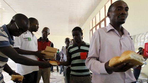 Students from a Burundi university queue to receive food rations as they camp outside the U.S. embassy in the capital Bujumbura, May 1, 2015