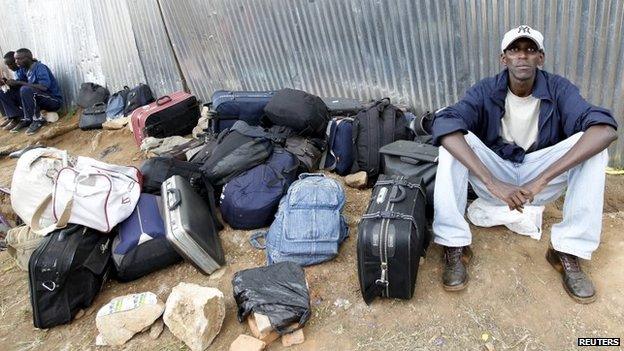 A student from a Burundi university sits next to bags of other students as they camp outside the U.S. embassy in the capital Bujumbura, May 1, 2015.