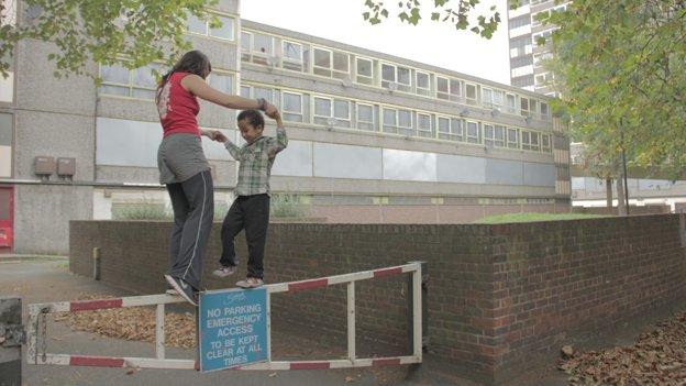 Woman and boy play on barrier