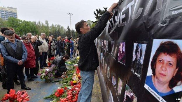 Activists put up a banner in front of the Trade Union House in Odessa, southern Ukraine, in memory of the people who died there