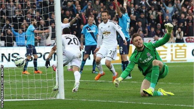 Swansea's Jefferson Montero wheels away to celebrate after scoring against Stoke