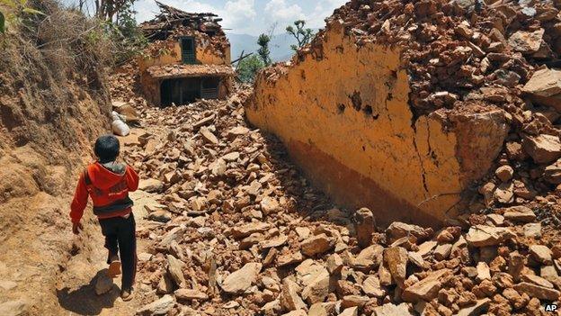 Child walking past rubble