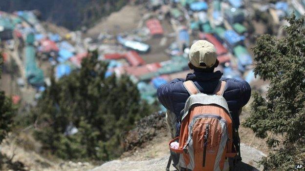 A local man sits above Namche, a village inhabited by mainly sherpas, in the Everest region in Nepal (6 April 2015)