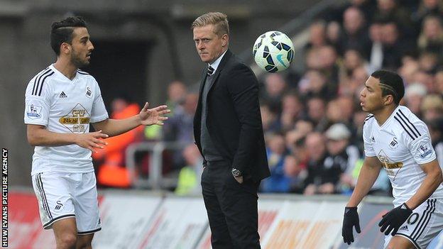 Swansea's manager Garry Monk looks on as Neil Taylor and Jefferson Montero restart from a throw-in against Stoke