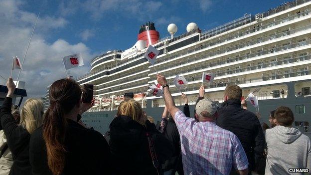 Onlookers waved flags as the Queen Elizabeth set sail