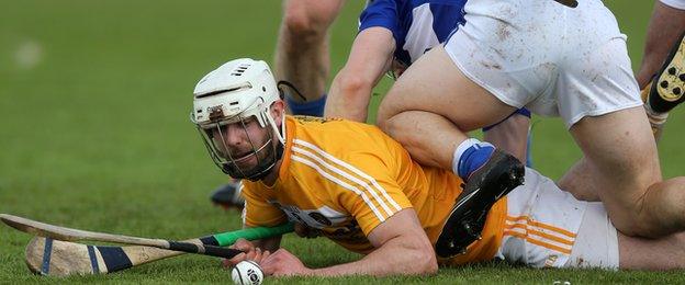 Antrim's Neil McManus and Laois full-back Cahir Healy hit the deck during the match in Ballycastle