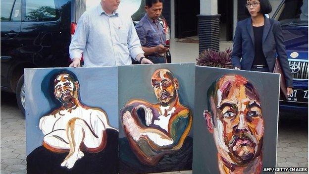 Lawyers Julian McMahon (L) and Veronica Haccou (R) display three self-portrait paintings made by Australian death row prisoner Myuran Sukumaran in Cilacap, Indonesia