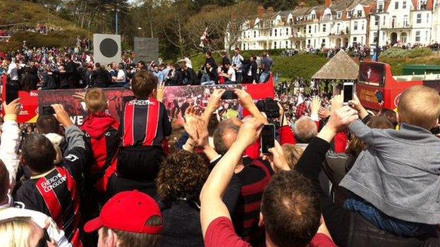 Supporters capture the bus on their phones