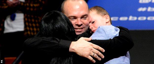 Bingham celebrates with his wife Michelle and son