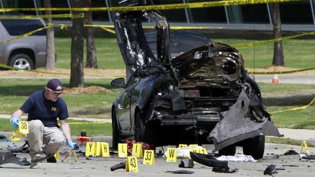 FBI agent examines car used by gunmen outside the centre in Garland. 4 May 2015