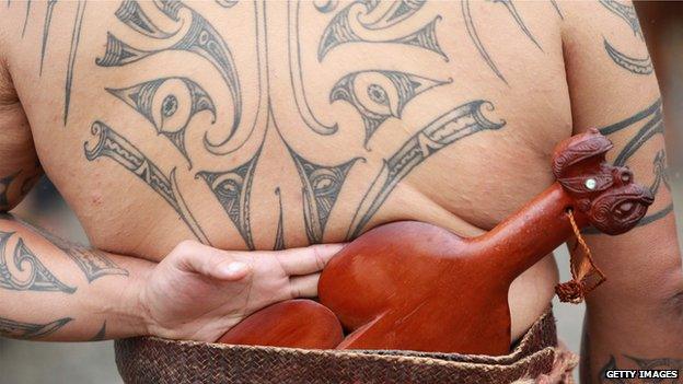 A Ta moko or tattoo on the back of a Waka Ama crew member of the beach as they celebrate Waitangi Day on 6 February 2014 in Paihia, New Zealand.